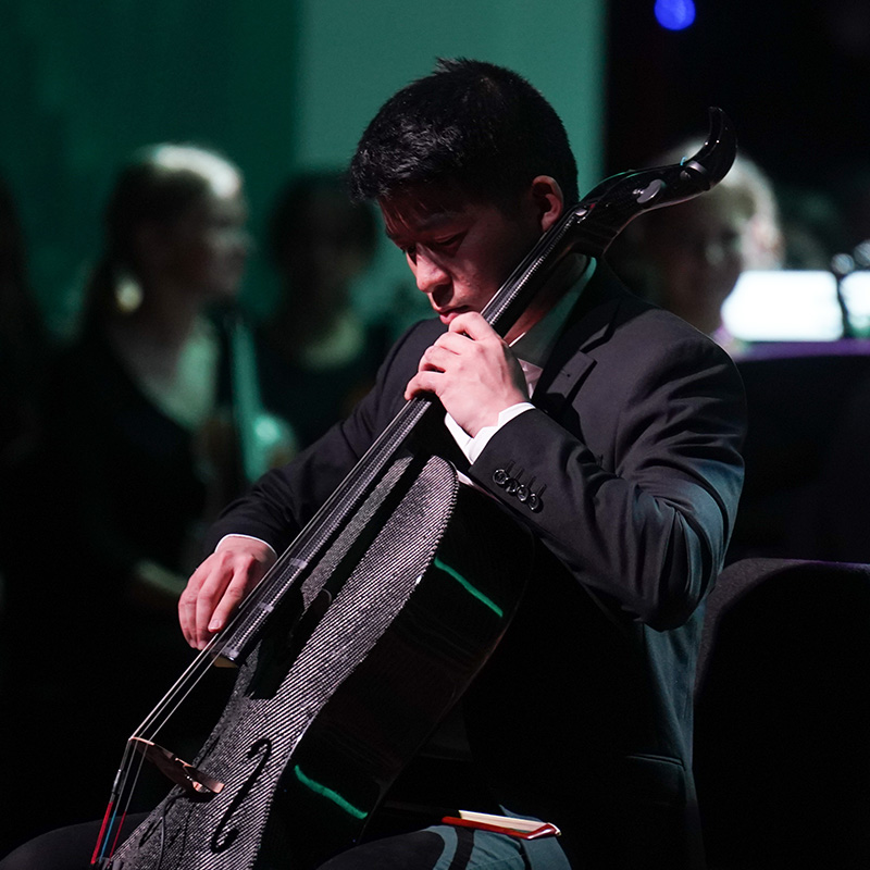 A male student plays the cello.