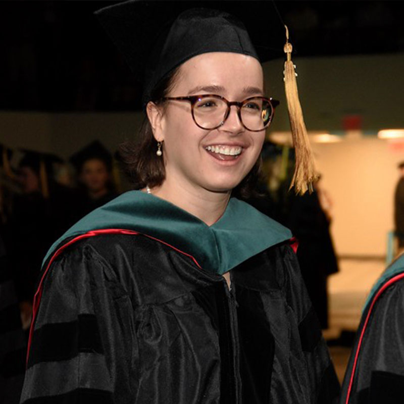 A Physical Therapy Graduate in their cap and gown.