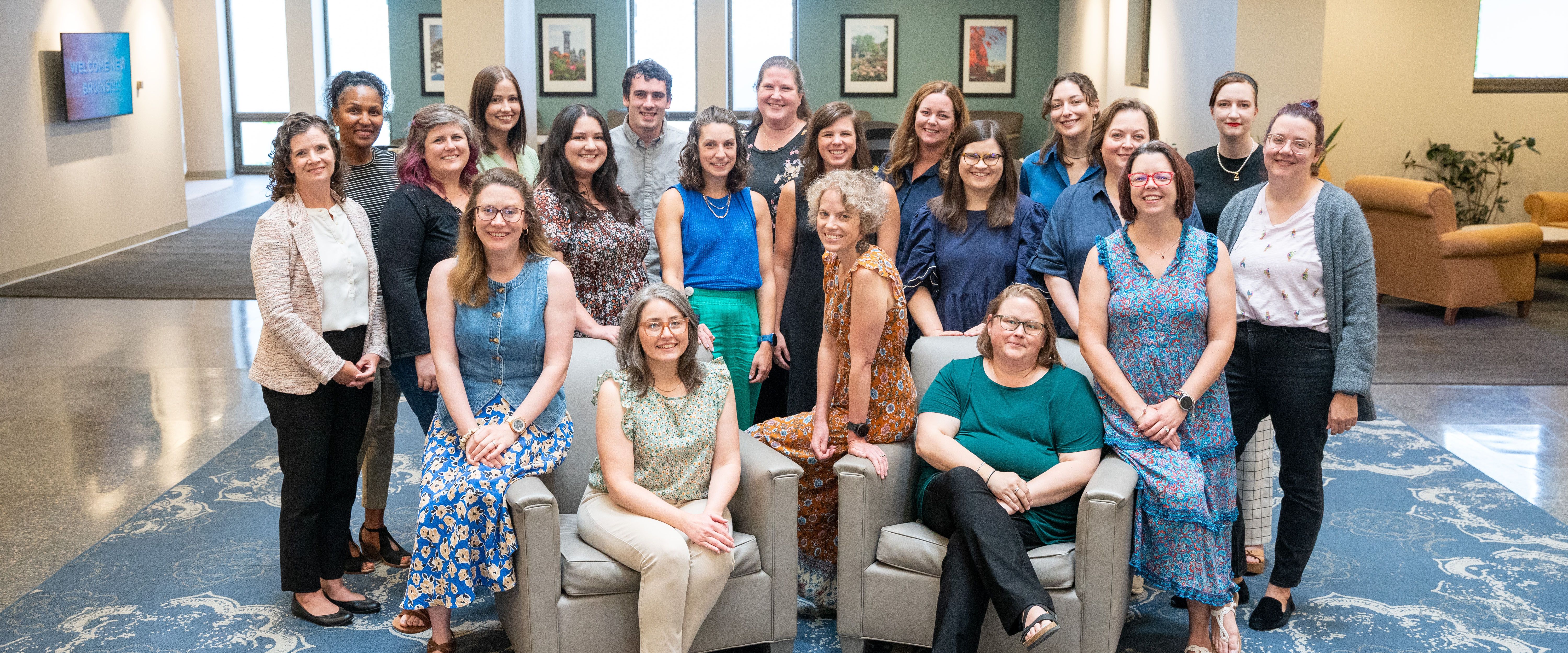 Faculty and staff group photo in the Bunch Library lobby.