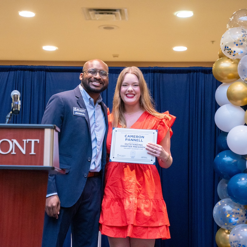 Student and faculty pose with the Outstanding Chapter President Award