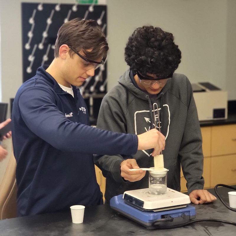 Two students work in a lab together